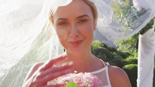 Portrait of caucasian bride smiling, looking at camera, taking of wale