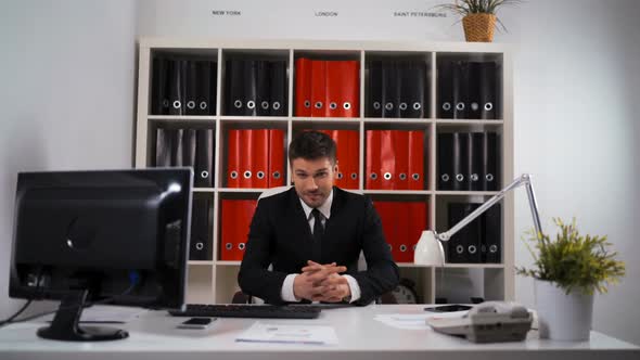 Portrait of Young Happy Businessman in Office