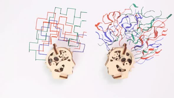 Stop Motion Animation Two Wooden Mechanical Heads Draw Various Abstractions on a White Background