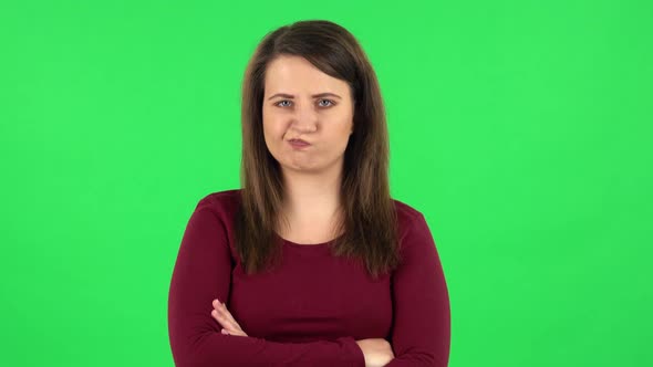 Portrait of Pretty Girl Is Very Offended and Looking Away . Green Screen