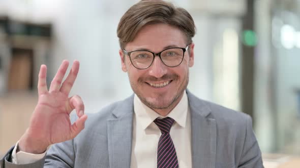 Portrait of Businessman Showing Ok Sign with Hand