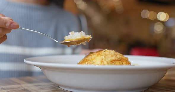 Woman enjoy the omelette curry rice