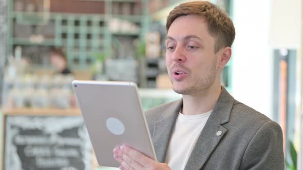 Portrait of Video Call on Tablet By Young Man