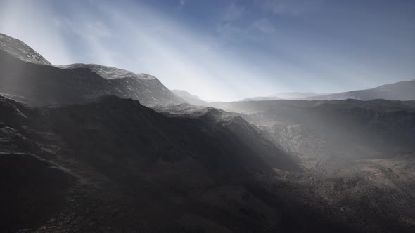 Sun Rays Over Mountains in a Valley