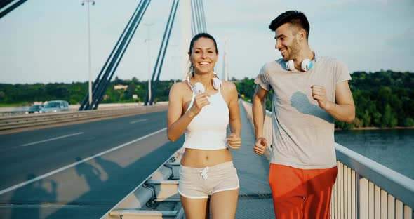 Attractive Man and Beautiful Woman Jogging Together