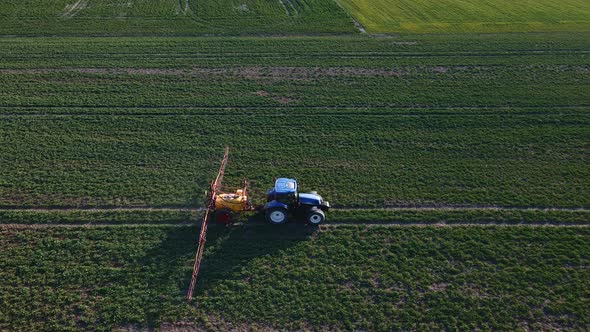 Tractor Spray Fertilizer on Agricultural Field Aerial View