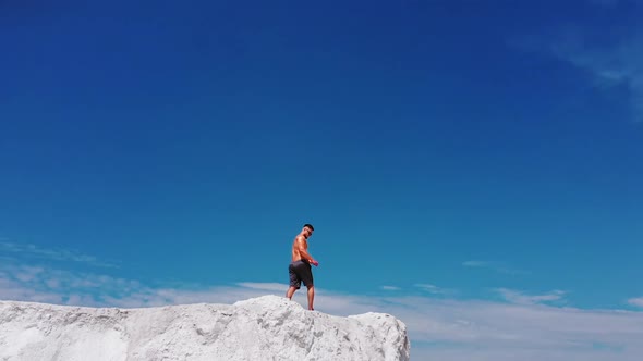 Professional bodybuilder posing. Concept of sport outdoors. Aerial view.