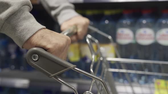 An Elderly Man's Hand on a Grocery Cart