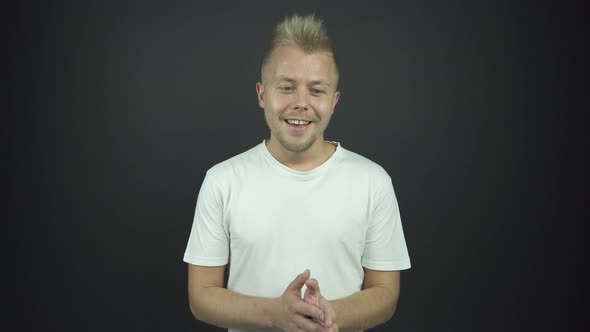 Handsome Guy Breathes Deeply with Enigmatic Smile in Studio