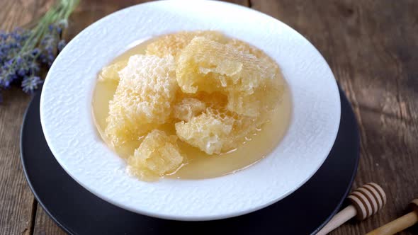 Honey and Honeycombs on a White Plate