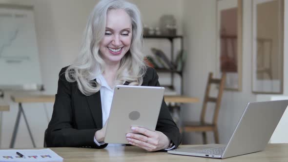 Online Video Chat By Senior Businesswoman on Tablet