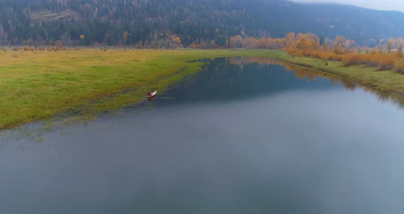 Man rowing a boat on a lake 