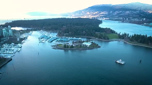 Beautiful drone shot of a lakeside city and mountain range.