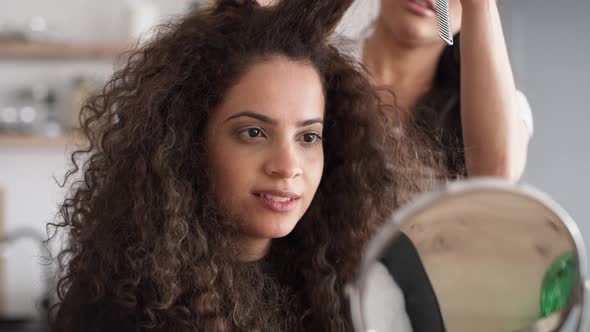 Video of women while trimming their hair at home. Shot with RED helium camera in 8K.