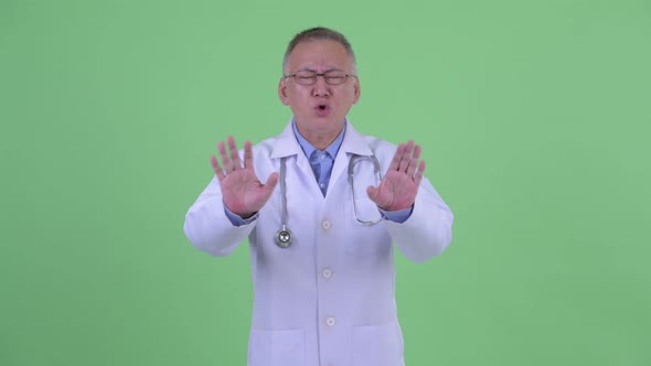 Serious Mature Japanese Man Doctor Waving Hand No