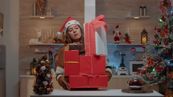 Festive Woman Putting Presents on Kitchen Counter