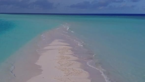 Aerial drone landscape of shore beach by blue lagoon with sand background