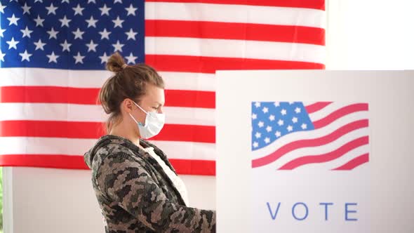 Voting at Polling Stations in the United States. Masked Men and Women Vote During the Covid-19