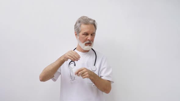 Confident Elderly Male Doctor with Stethoscope Isolated on White Background