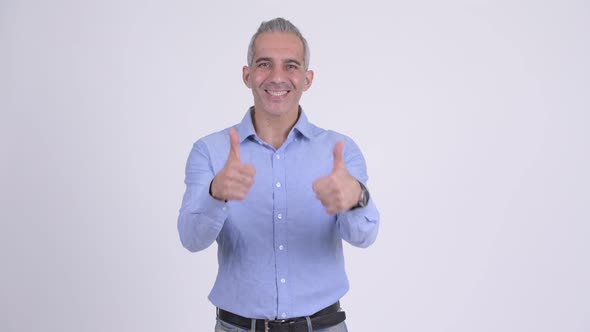 Happy Persian Businessman Looking Excited and Giving Thumbs Up