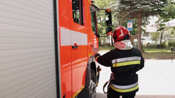 Brave Firefighter in Protective Gear is Equipped with All the Necessary Equipment to Deal with Fire