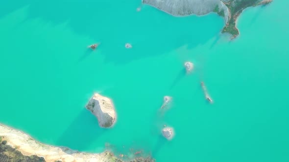 An artificial lake in chalk quarry. view from drone. Turquoise water background