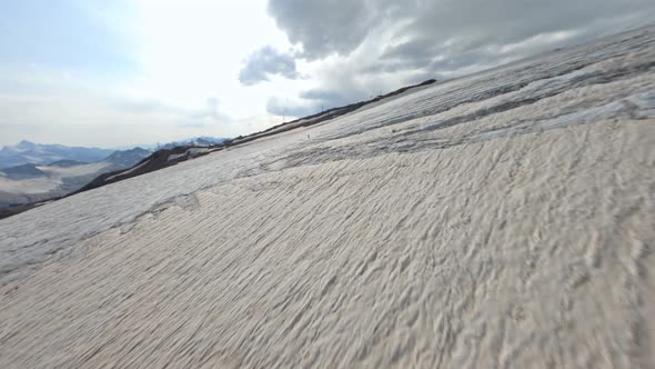 Aerial View Man Walking Over Cracked Natural Glacier Texture Broken Ice Surface