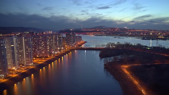 Aerial Hyperlapse of a Residential Area on the Riverbank at Sunset