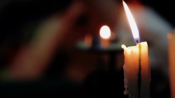 Burning Candle Against the Background of Female Showing Tarot Card, Magic