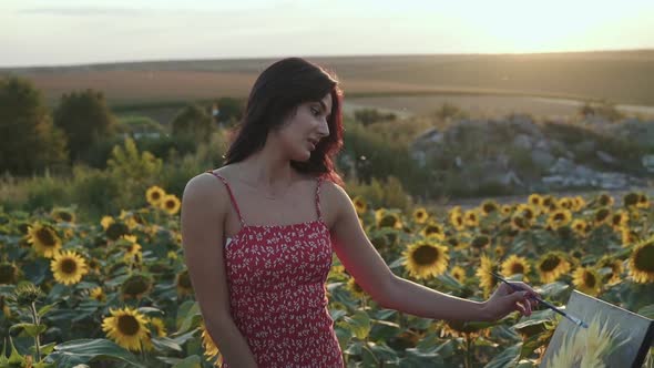 Beautiful View of Pretty Girl Painting a Sunflower Among Flower Field