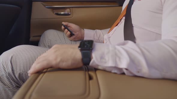 Businessman Uses Phone in Car. Expensive Watch on My Hand. Leather Car Interior