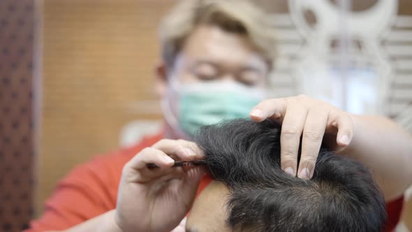 A Closeup Shot of Master Hairdresser Does Hairstyle and Style with a Comb