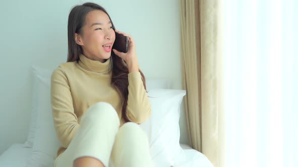 Young asian woman use smart phone in room