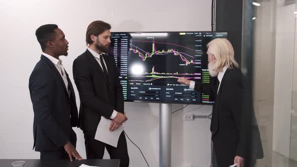 Businessmen Checking Stock Market on Digital Board