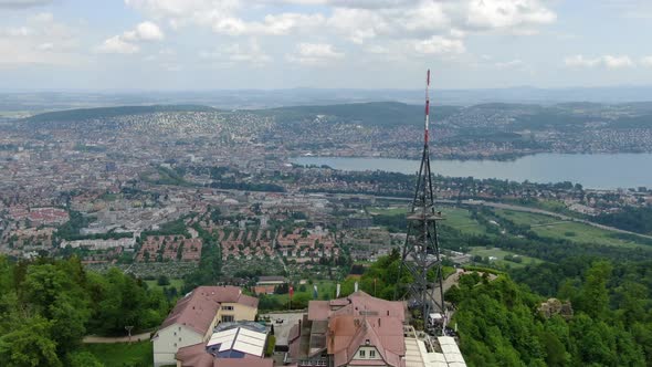 Drone passing the summit of Uetliberg and flying towards Zurich, Switzerland