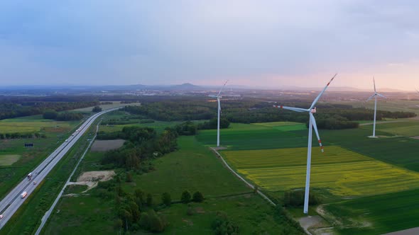 Wind Turbine On A Field next to Highway