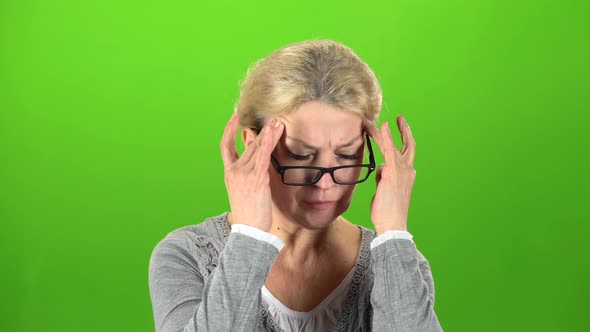 Woman Suffers From a Headache. Green Screen