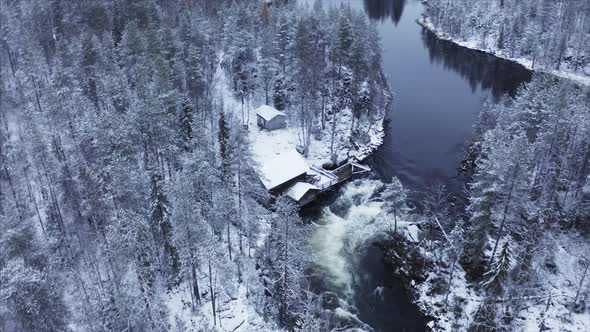 drone footage of a cabin in a snowy landscape in finland