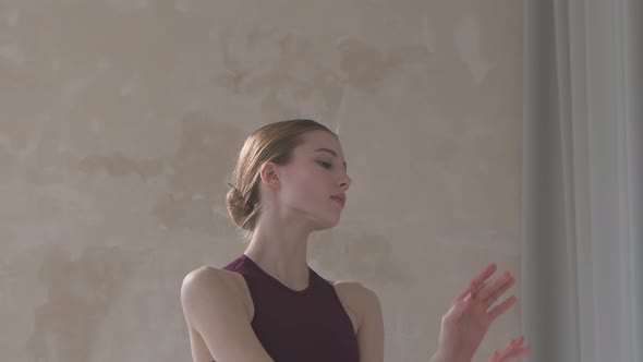 Beautiful Young Woman Dancer in Black Stage Dress Rehearses Dance Moves. Dance Lesson in Studio with