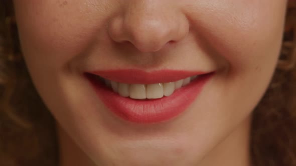 Close Up of a Charming Woman Smile with Perfect Natural Teeth and Bright Lipstick