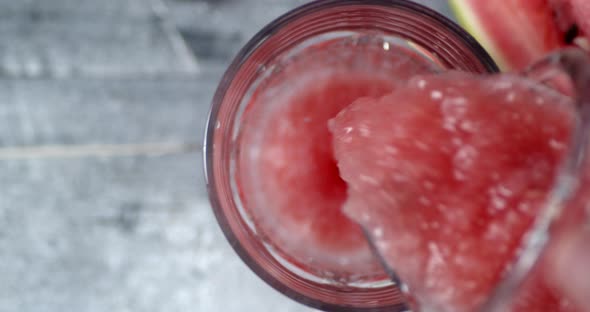 Watermelon Smoothie Pour Into a Glass with Air Bubbles. 