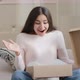 Amazed Arabian Latino Female Customer Shopper Buyer Sitting on Sofa Unpacking Postal Shipping - VideoHive Item for Sale
