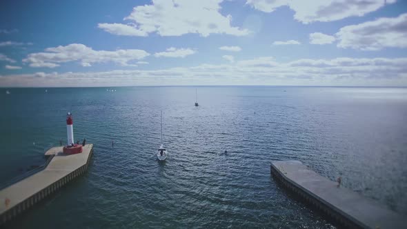 Drone flying over lake Ontario away from Oakville marina and lighthouse, Canada