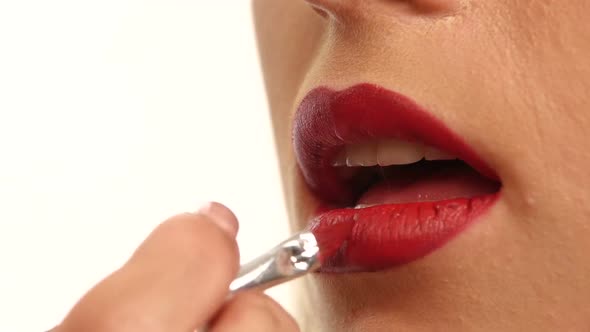 Woman's Lips with Bright Fashion Red Glossy Makeup. Close Up