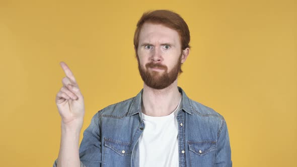 Redhead Man Waving Finger To Refuse, Yellow Background