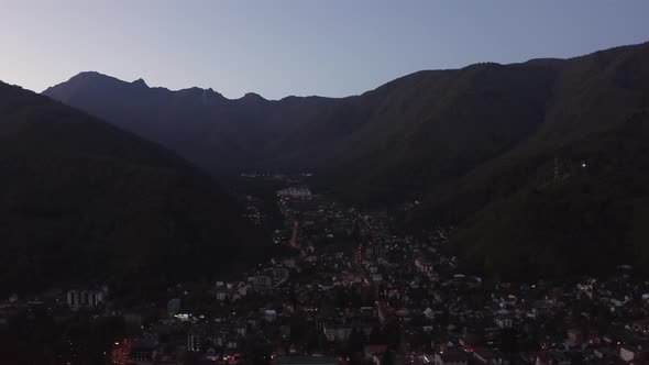 Aerial View From Above Flying Over Night Touristic Village with Glowing Light at Mountain Achishkho