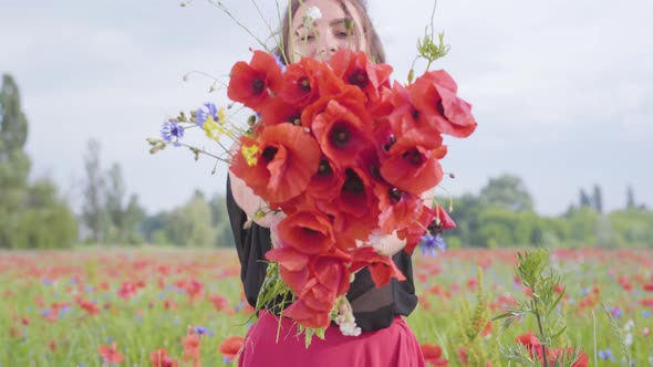 Portrait Pretty Young Girl Holding Bouquet of Flowers in Hands Looking in the Camera Standing in a