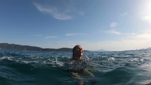 Slow-motion Shot of Carefree Girl Playing Splashing Water and Having Fun