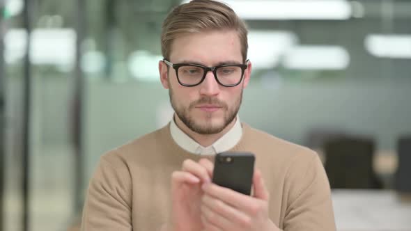 Young Creative Man Using Smartphone