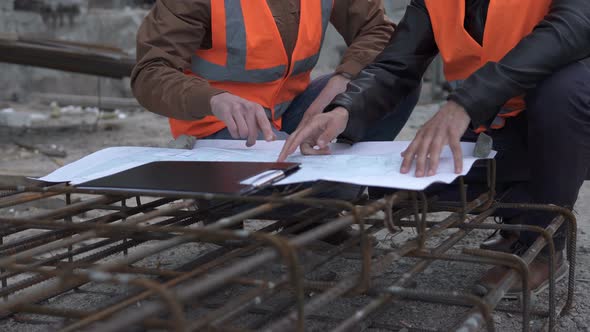 Discussion of construction drawings at the construction site.